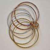 Skinny metal bangle and adjustable finger ring set.