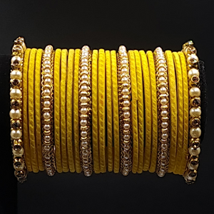 Traditional yellow velvet bangles with broad side pearl kangan