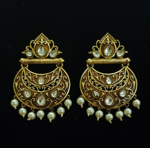 Traditional copper gold kundan and pearl earrings.