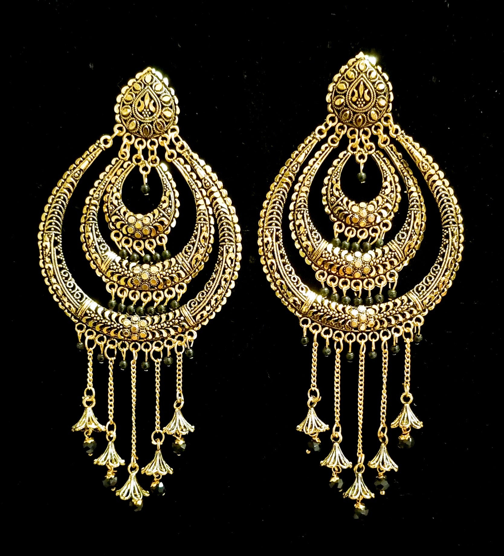 Long jhumka style earrings with tassels.