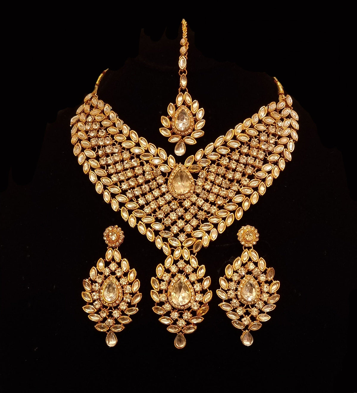 Designer stone studded kundan bridal set with earrings and mathapatti.