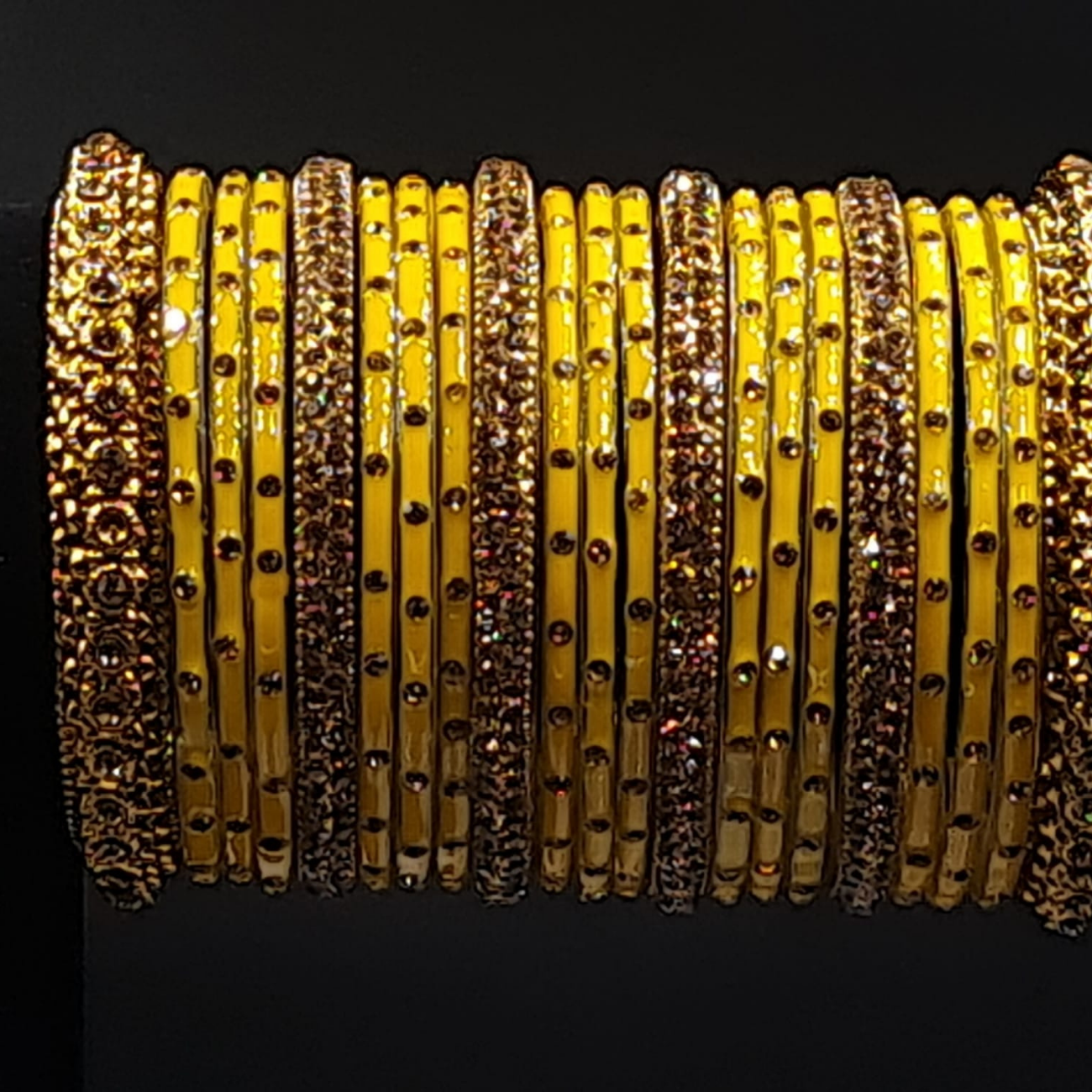 Stone studded yellow and golden bangles set