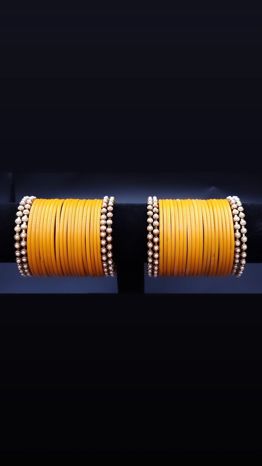 Designer yellow glass bangles with pearl metal bangles set. Designer yellow glass bangles with pearl metal bangles set.