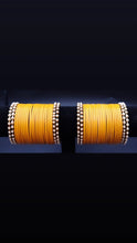 Load image into Gallery viewer, Designer yellow glass bangles with pearl metal bangles set.