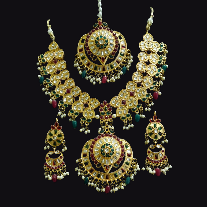 Red & green kundan moti necklace set with earrings and tikka.